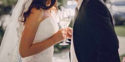 gorgeous wedding couple enjoys champagne sitting in the restaurant